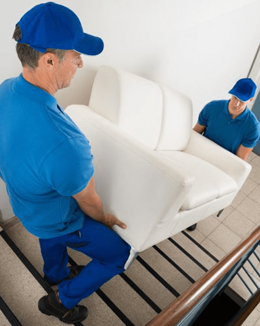 burnaby moving company carrying a couch downstairs